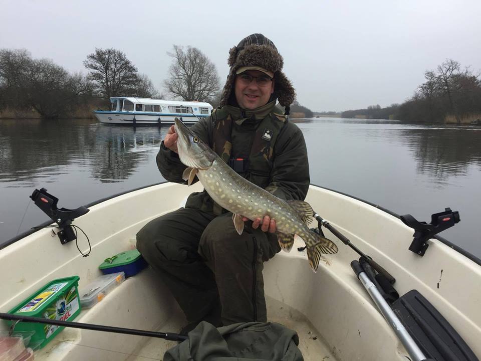 A customer on a guided day with a small jack pike. Photo